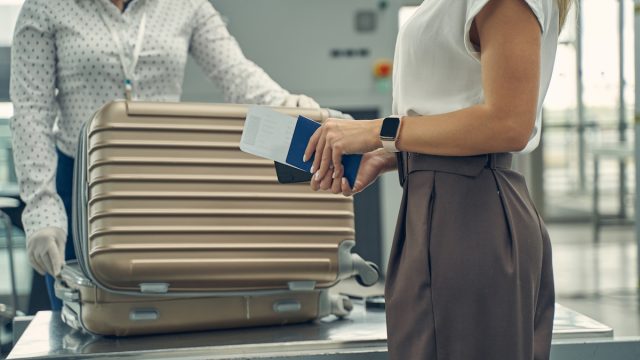Airport security looking through passenger's luggage.