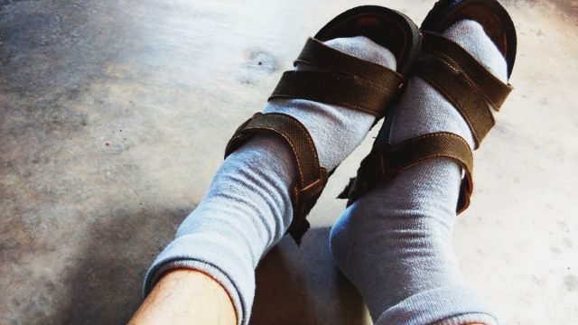 Wearing socks with sandal.
