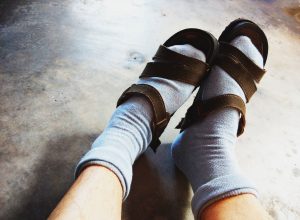 Wearing socks with sandal.