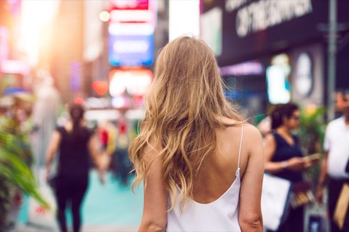 woman standing with her shoulders back