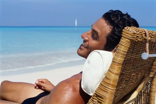 man sunbathing at the beach