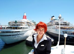 Cruise Staff Member in Front Of Ship