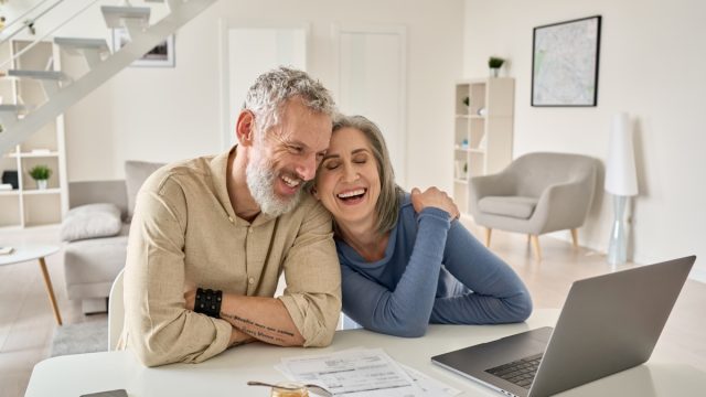 Happy Older Couple Using Laptop