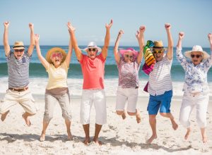 Portrait of senior friends at the beach on a sunny day