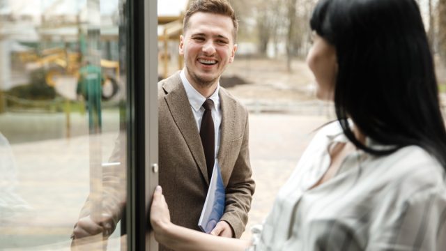 Woman Holding the Door Open
