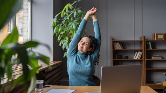 Happy,Businesswoman,Warming,Up,Body,And,Muscles,At,Workplace,,Feeling