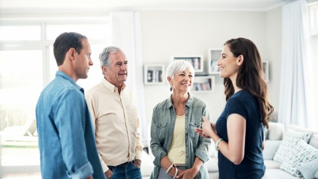 Shot of a young couple and their elderly parent spending some time together at home