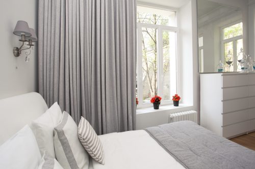 gray and white bedroom with gray curtains