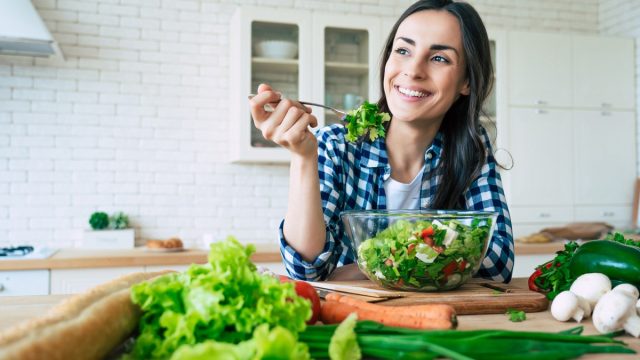 smiling woman eating healthy meal
