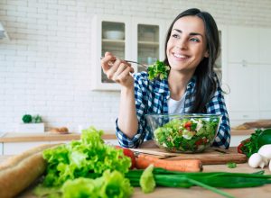 smiling woman eating healthy meal