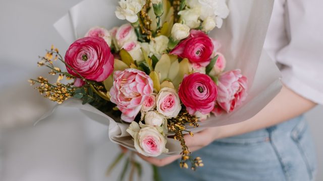 woman holding bouquet of flowers