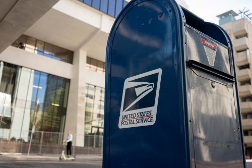 A close up of a USPS mailbox