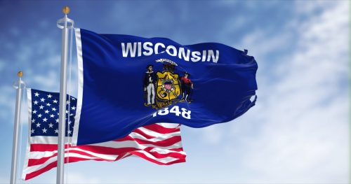 The Wisconsin state flag waving along with the national flag