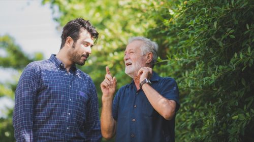 Adult hipster son and old senior father stay for work at home, two generations have a beard talking together and relaxing with smile, happy enjoy living to isolation quarantine at home, father's day