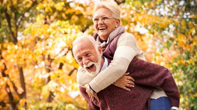 Older Man and Woman Enjoying Fall Scenery