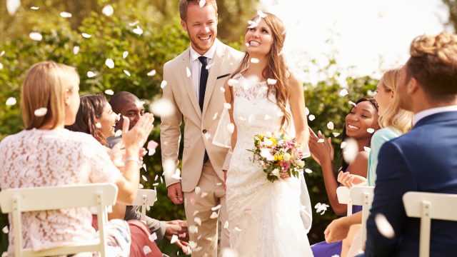 Guests Throwing Confetti Over Bride And Groom At Wedding