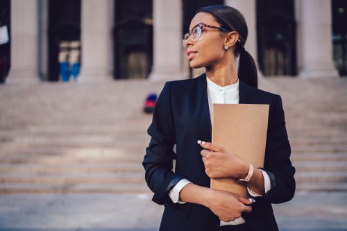 Female lawyer standing in front of a court house