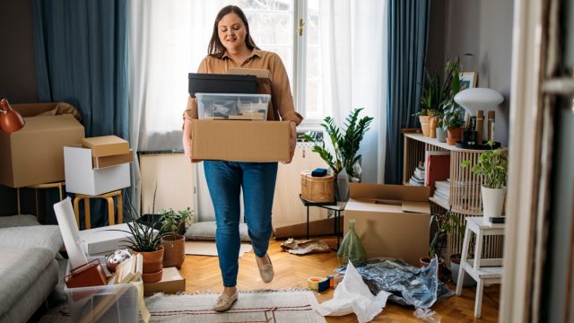 woman carrying boxes with personal belongings