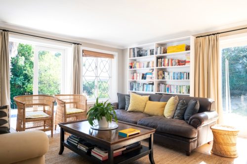Sofa and chairs in living room. Interior of simple home. Furniture is arranged in sitting area.