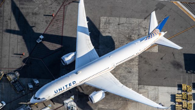 An aerial shot of a United Airlines plane sitting on a runway