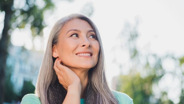 Woman with Shiny Gray Hair Looking into Distance