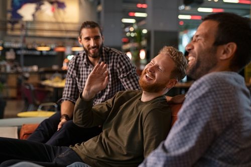 group of male friends hanging out at a bar telling one line jokes