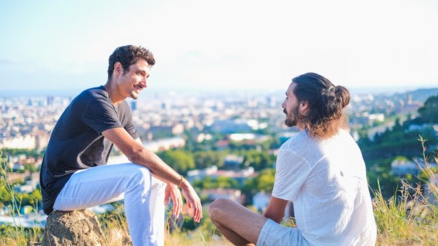 two men having a deep conversation outside