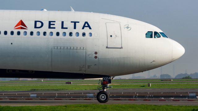 A Delta Air Lines jet sitting on the runway at an airport