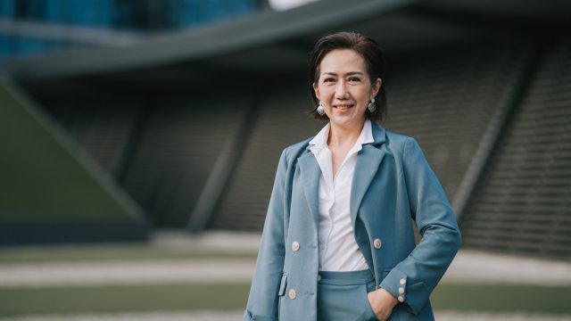 successful Asian Chinese female entrepreneur looking at camera smiling