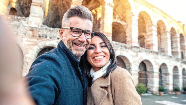 Happy married couple of tourists taking selfie photo smiling
