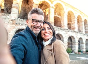Happy married couple of tourists taking selfie photo smiling