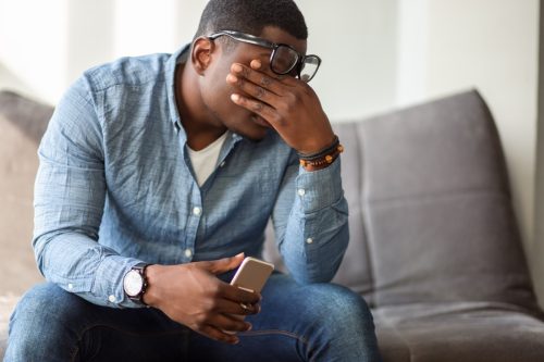 man feeling frustrated from phone call