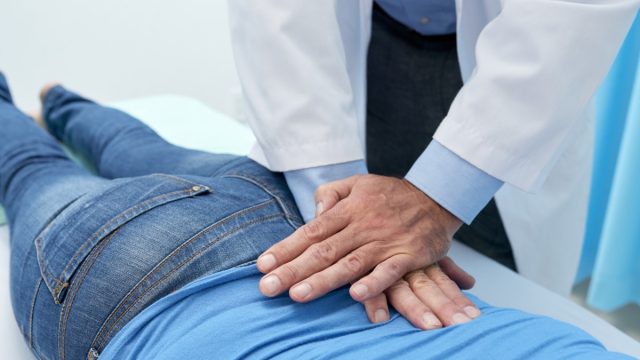 chiropractor adjusting back