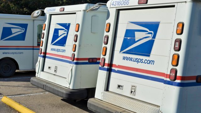 Fort Collins, Colorado, USA - August 10, 2013: Delivery vehicles parked at the United States Post Office in downtown Fort Collins. With almost 600,000 employees, the United States Postal Service is the second largest civilian employer in the United States.