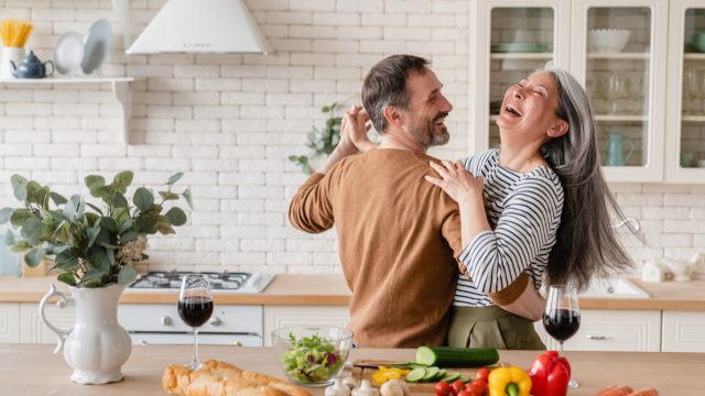 man and woman dancing in the kitchen