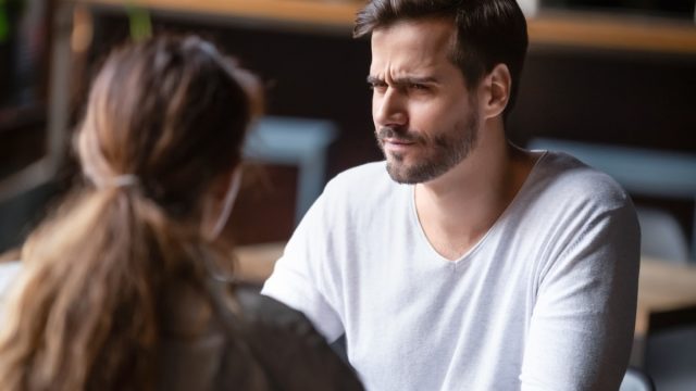 Man looking skeptically at woman