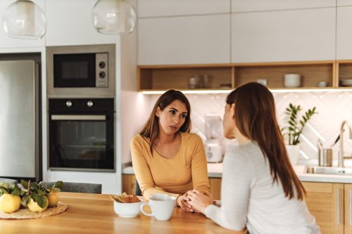 Woman having healthy friendship, having bad news.