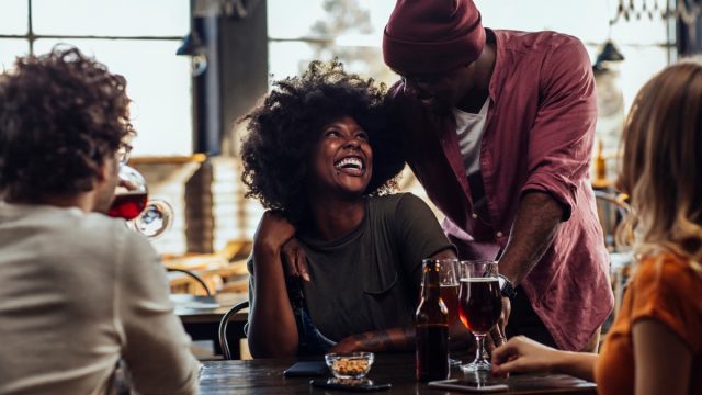 couple hanging out with friends at a bar