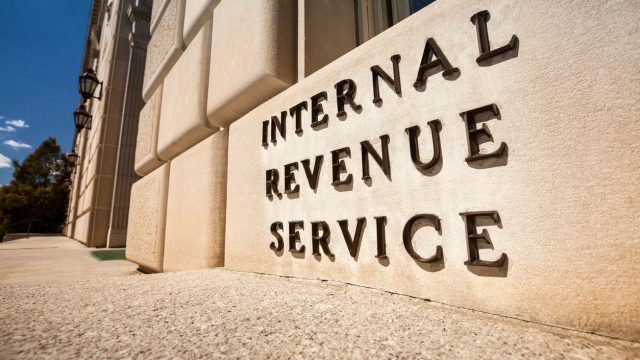 A close up of a sign that says Internal Revenue Service outside the IRS headquarters in Washington, D.C.
