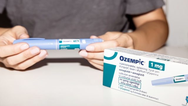Female hands holding an insulin pen. Ozempic Insulin injection pen or insulin cartridge pen for diabetics. Medical equipment for diabetes parients. Copenhagen, Denmark - September 4, 2023.