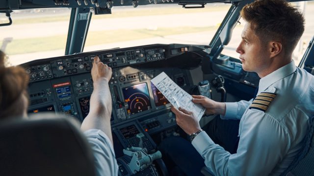 Airline captain and first officer sitting in the cockpit