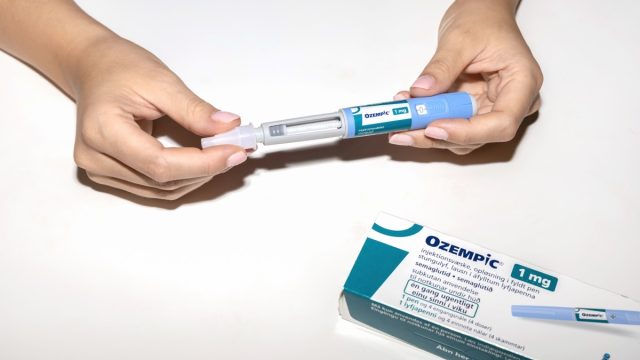 holding ozempic pen