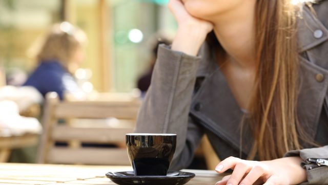 Impatient woman waiting on a cafe terrace
