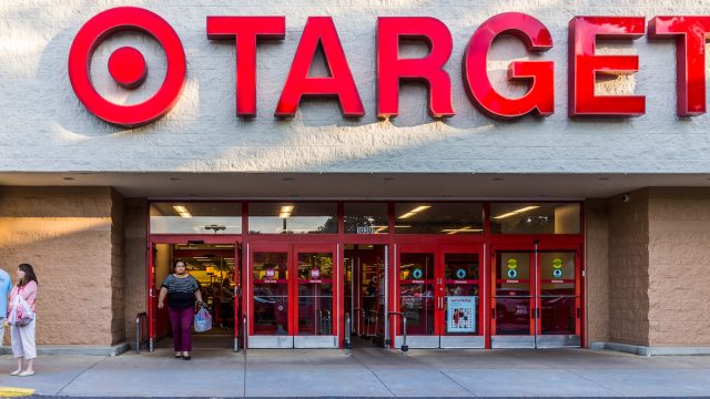 arget store entrance with woman walking out with sign