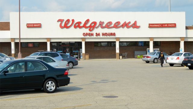 "Chicago, USA - September 17, 2012: A lady shopper leaves a Walgreens store and crosses the parking lot to her car. Walgreens was established in Chicago in 1901, just a few miles from this 24 hour store - one of over 8300 in the USA."