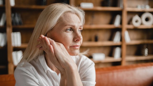 Psychologist appointment. Stressed sad tired exhausted caucasian middle aged mature businesswoman freelancer relaxing on the couch sofa, thinking about family marriage work problems at work office