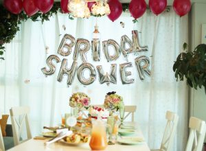 bride celebrating her upcoming wedding with balloons, table setting, and bridal shower games