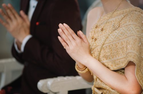 Close up of man and woman during Thai wedding ceremony