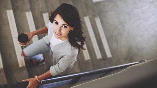 Portrait of woman walking up the stair.