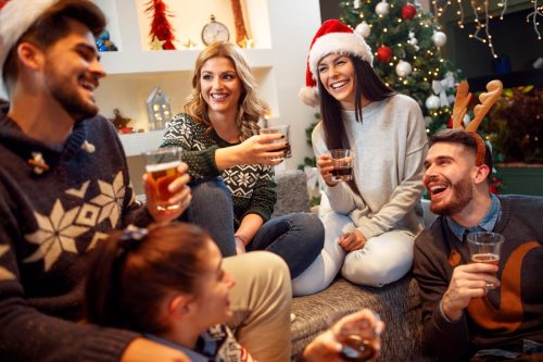 group of friends joking around at a christmas party